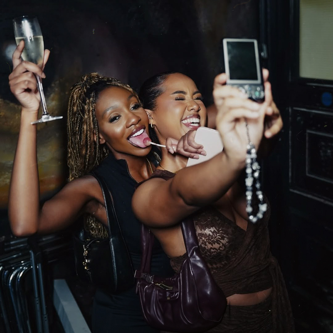 Friends capturing a joyful night out together at Timeless Nostalgia